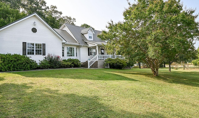 view of front of property with covered porch and a front lawn