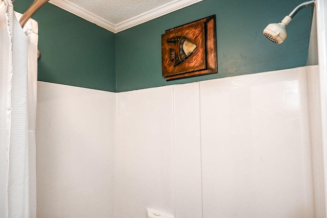 interior details with ornamental molding, a textured ceiling, and walk in shower