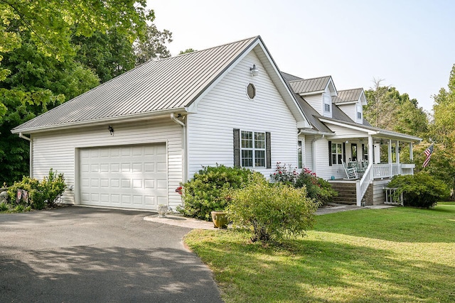 view of front of property with a front lawn, a porch, and a garage