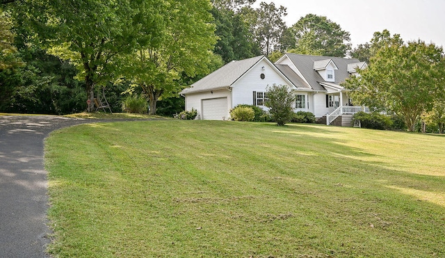 exterior space featuring a garage and a front lawn