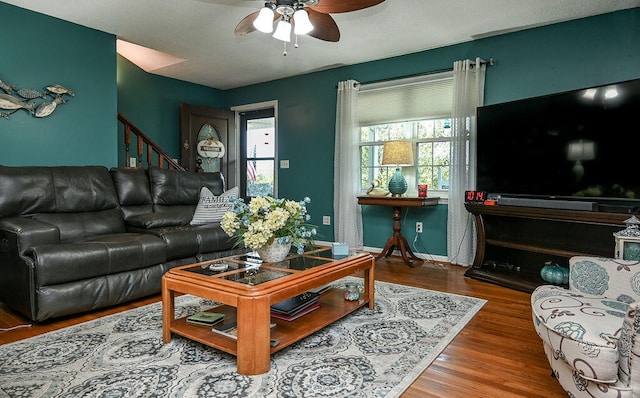 living room with hardwood / wood-style flooring and ceiling fan