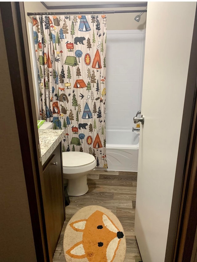 full bathroom featuring vanity, wood-type flooring, shower / tub combo, and toilet