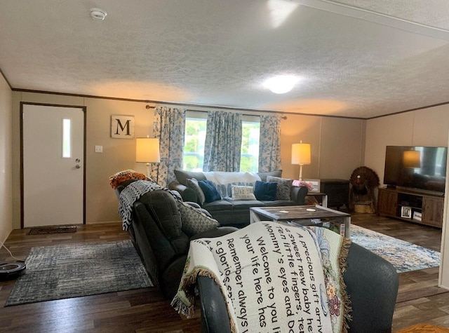 living room featuring crown molding, dark hardwood / wood-style flooring, and a textured ceiling