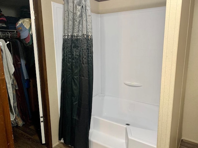 bathroom featuring shower / bath combo with shower curtain and wood-type flooring