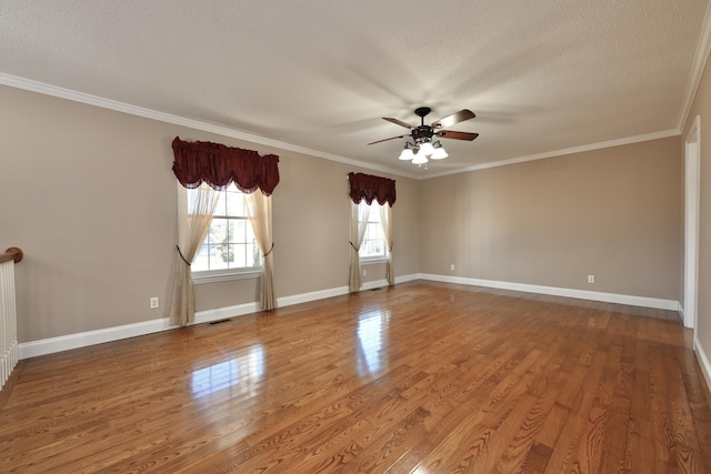 spare room featuring wood-type flooring, ornamental molding, and a textured ceiling