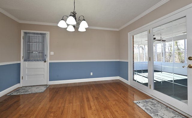 interior space featuring hardwood / wood-style flooring, ornamental molding, and a chandelier