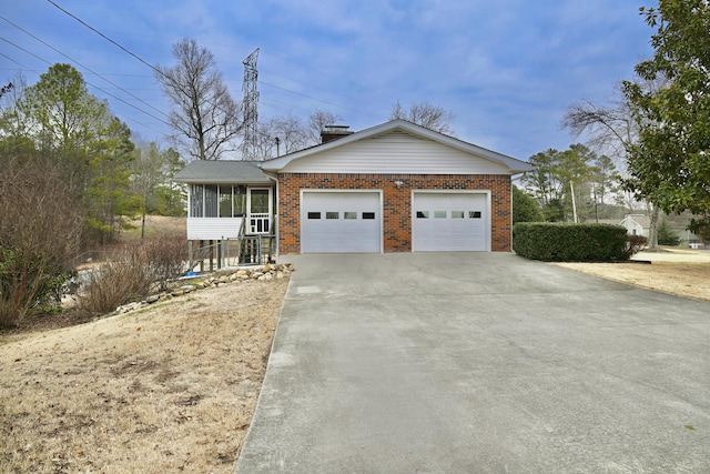 view of front of property featuring a garage and a sunroom