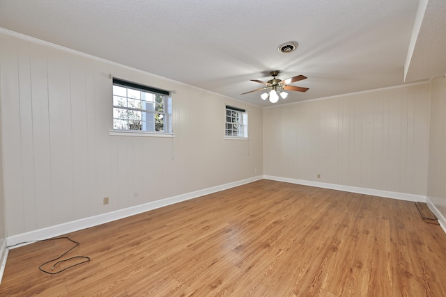 spare room with crown molding, ceiling fan, light hardwood / wood-style floors, and a textured ceiling