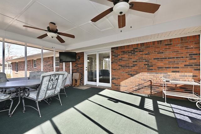 sunroom / solarium featuring ceiling fan