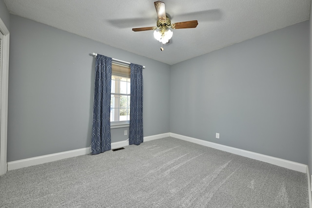 unfurnished room featuring ceiling fan, carpet flooring, and a textured ceiling