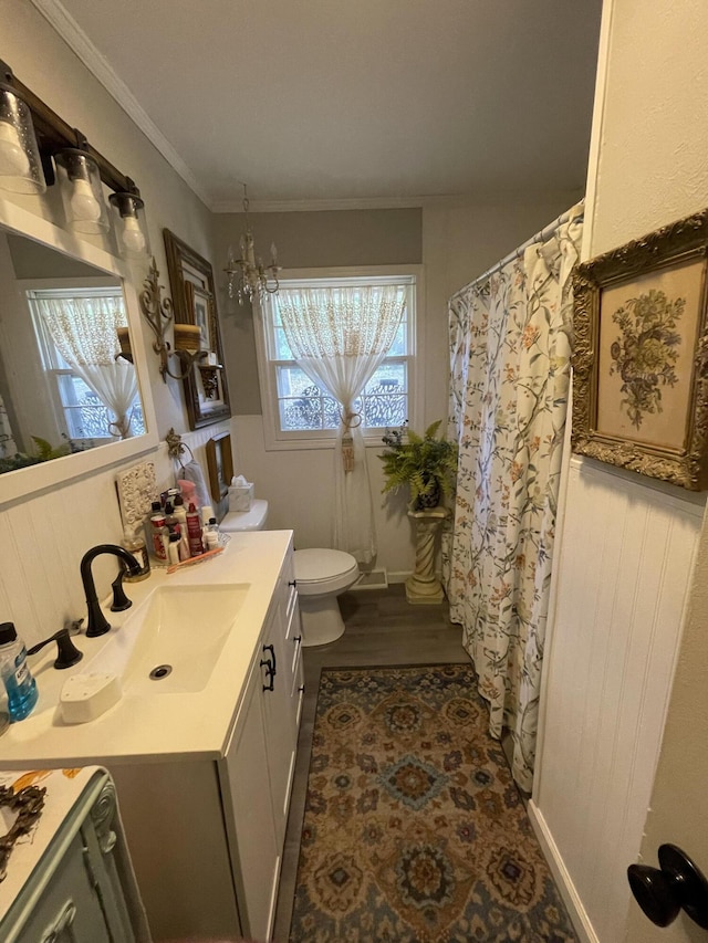 4010 Elm Ln NE, Cleveland, TN 37312 - full bathroom featuring vanity, toilet, a chandelier, ornamental molding, and wood finished floors