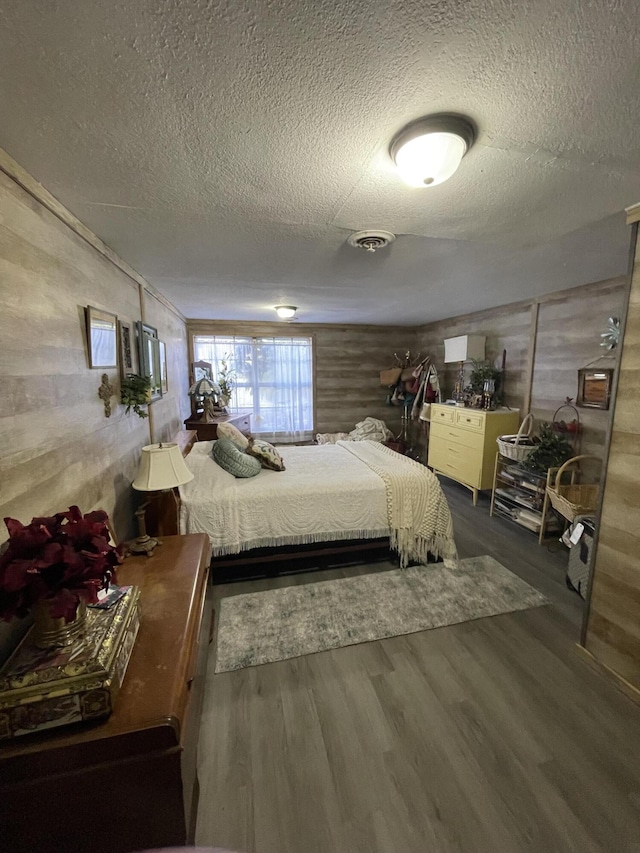 4010 Elm Ln NE, Cleveland, TN 37312 - bedroom with a textured ceiling, wood finished floors, and wood walls
