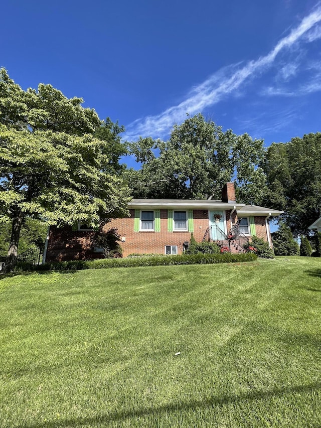 4010 Elm Ln NE, Cleveland, TN 37312 - ranch-style house with a front yard, brick siding, and a chimney