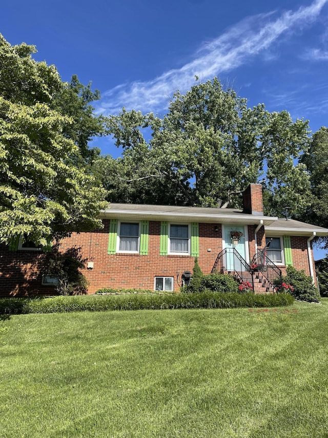4010 Elm Ln NE, Cleveland, TN 37312 - ranch-style house with brick siding, a front lawn, and a chimney