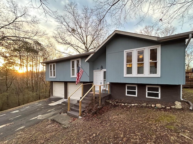 bi-level home featuring a garage and driveway