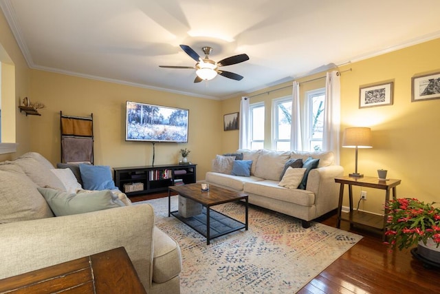 living room with ornamental molding, wood-type flooring, and ceiling fan