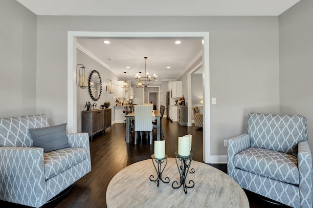 living room featuring crown molding, dark hardwood / wood-style flooring, and an inviting chandelier