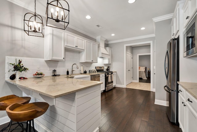 kitchen featuring sink, decorative light fixtures, light stone counters, white cabinetry, and stainless steel appliances