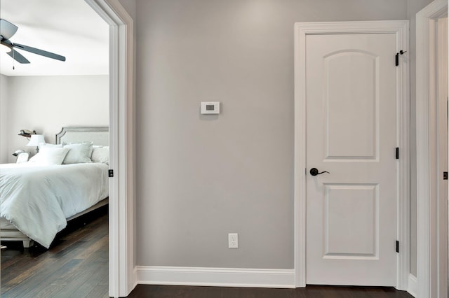 bedroom with dark hardwood / wood-style flooring and ceiling fan