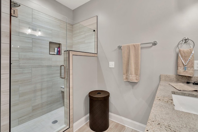 bathroom featuring vanity and an enclosed shower