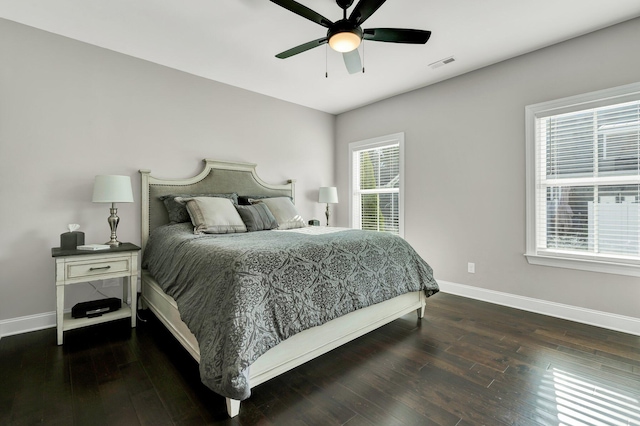 bedroom with ceiling fan and dark wood-type flooring