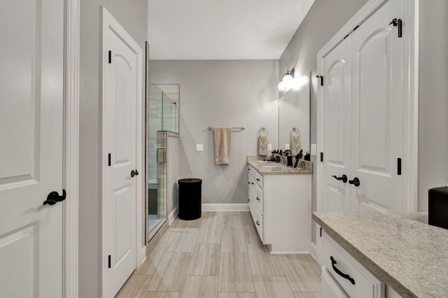 bathroom featuring vanity and a shower with shower door