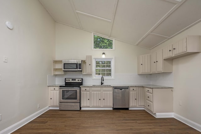 34 Miller Cove Cir, Signal Mountain, TN 37377 - kitchen with stainless steel appliances, dark wood-style floors, backsplash, cream cabinetry, and high vaulted ceiling