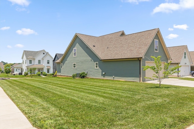 9614 Mulberry Gap Way, Ooltewah, TN 37363 - view of side of home with driveway, roof with shingles, a yard, and a garage