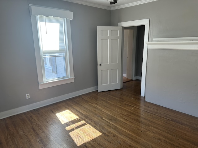 unfurnished room with baseboards, dark wood-style flooring, and crown molding