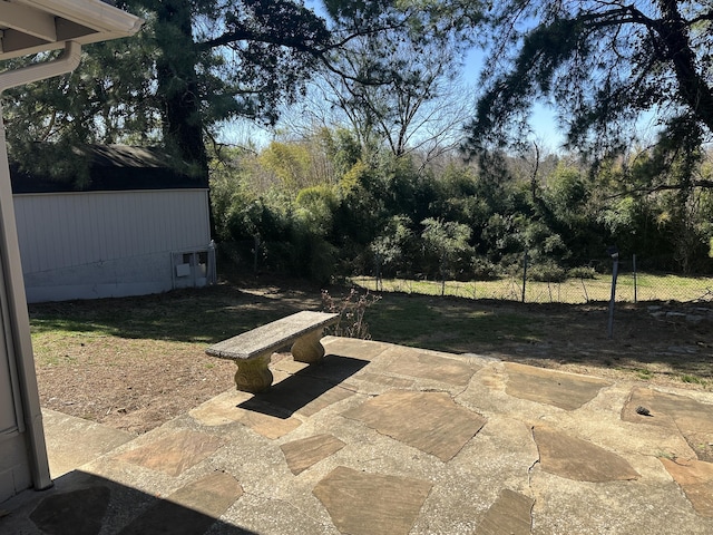 view of patio / terrace with an outbuilding and fence