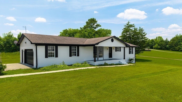 373 Kile Ln SW, Cleveland, TN 37311 - single story home featuring a garage, covered porch, driveway, a front yard, and brick siding