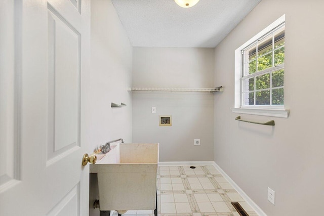 373 Kile Ln SW, Cleveland, TN 37311 - laundry room featuring washer hookup, a textured ceiling, baseboards, and tile patterned floors