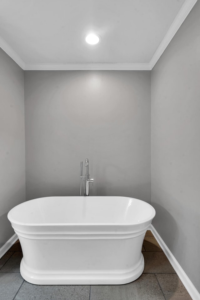 full bathroom with crown molding, baseboards, and a freestanding bath