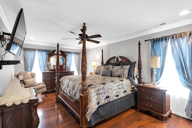 bedroom featuring ceiling fan, visible vents, dark wood-style flooring, and ornamental molding