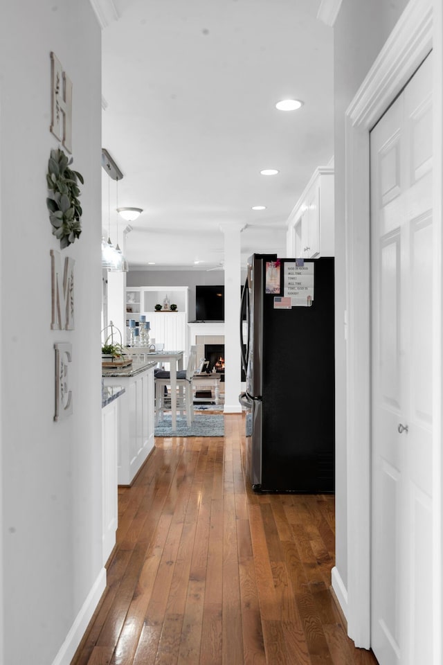 corridor featuring recessed lighting, dark wood finished floors, and baseboards