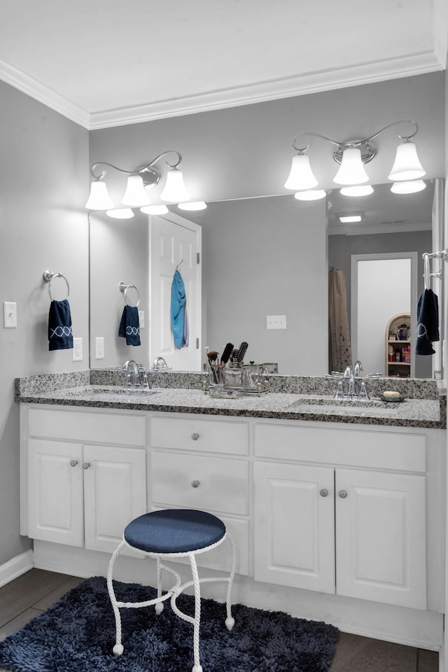 full bathroom featuring double vanity, tile patterned flooring, a sink, and crown molding