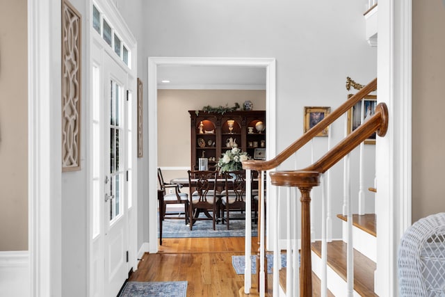 foyer featuring stairs, wood finished floors, and french doors