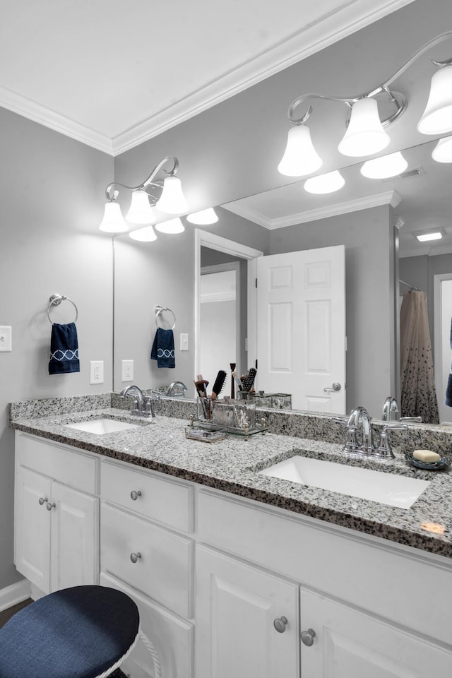 full bath featuring double vanity, a sink, and crown molding