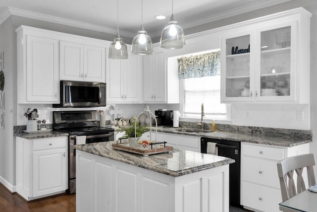 kitchen featuring stainless steel appliances, white cabinetry, and a sink