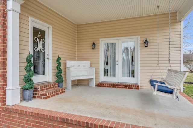 doorway to property featuring brick siding and french doors