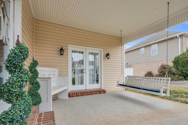 property entrance featuring a patio area and french doors