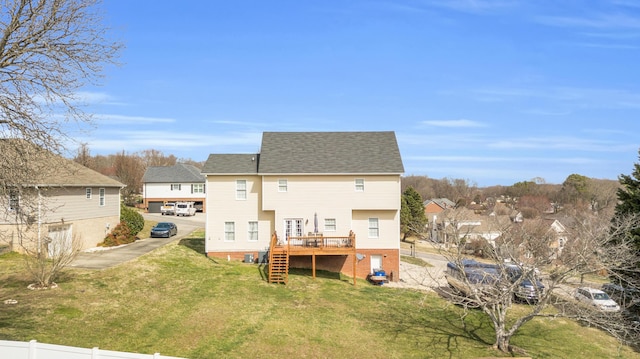 back of house with a lawn, stairway, roof with shingles, fence, and a wooden deck