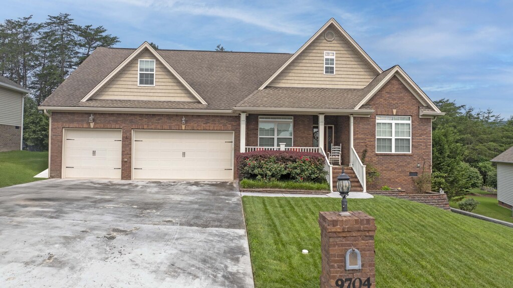 9704 Starry Way, Soddy-Daisy, TN 37379 - view of front of house with driveway, a porch, a front lawn, and brick siding