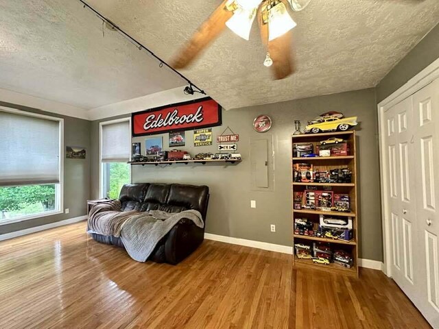 2996 Sugar Grove Valley Rd, Harriman, TN 37748 - bedroom featuring a textured ceiling, baseboards, wood finished floors, a ceiling fan, and a closet