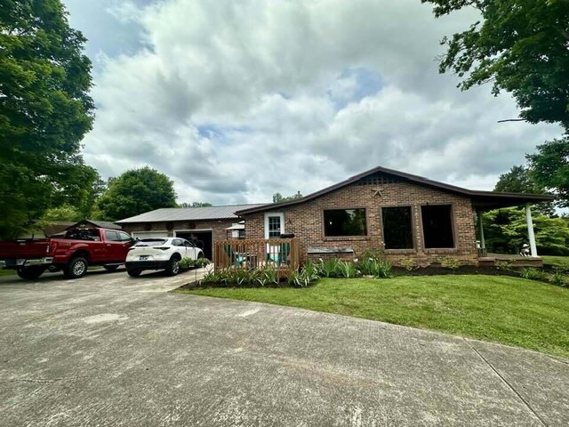 2996 Sugar Grove Valley Rd, Harriman, TN 37748 - ranch-style home with a garage, brick siding, a front yard, and driveway