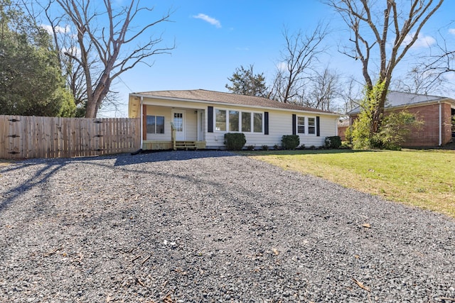 1704 Georgetown Rd NW, Cleveland, TN 37311 - view of front of house featuring gravel driveway, roof with shingles, fence, and a front lawn