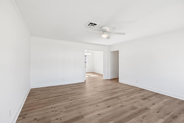 1704 Georgetown Rd NW, Cleveland, TN 37311 - empty room featuring visible vents, baseboards, ornamental molding, wood finished floors, and ceiling fan with notable chandelier