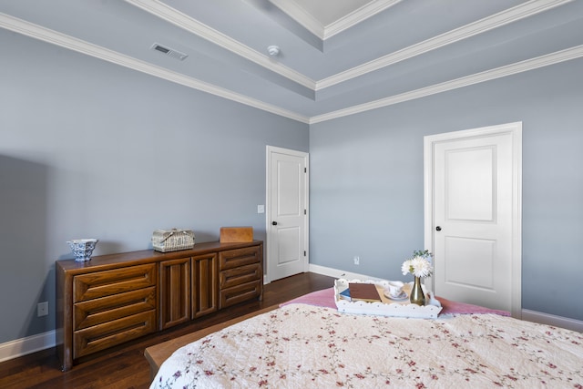 bedroom with a raised ceiling, crown molding, and dark wood-type flooring