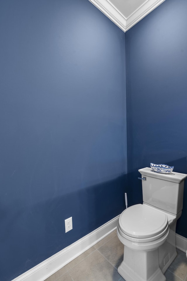 bathroom featuring toilet, tile patterned flooring, and ornamental molding