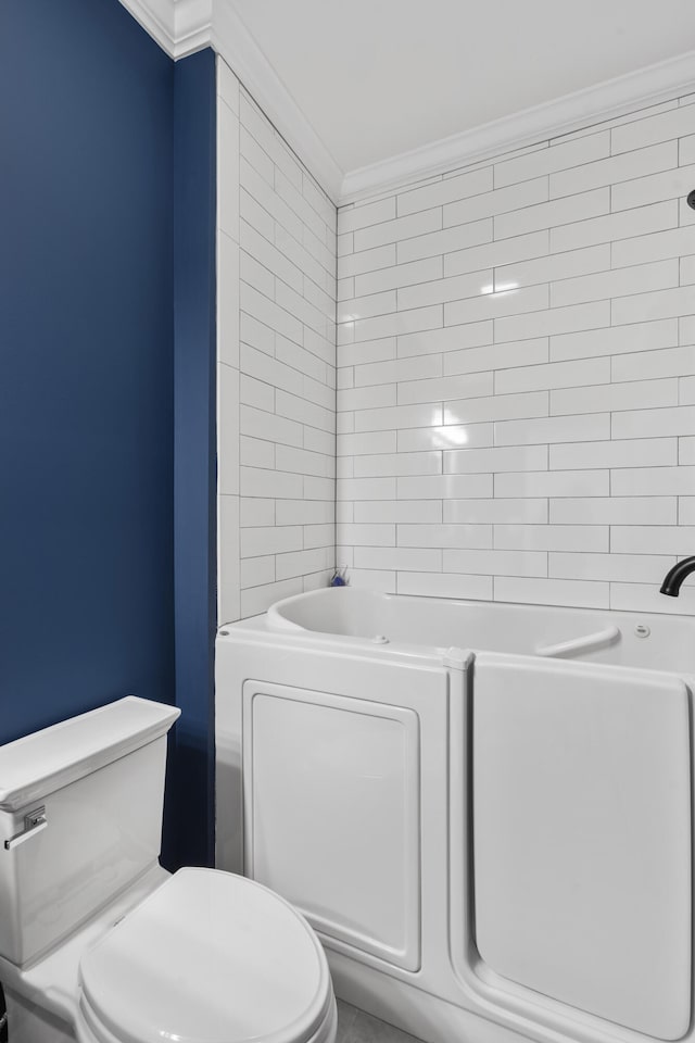 bathroom with  shower combination, toilet, and crown molding